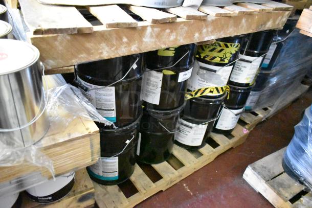 12 Pro Guard chemical barrels, including 5-gal 2114 Moisture Cure Primer Clear Blue, stacked on wooden pallets.