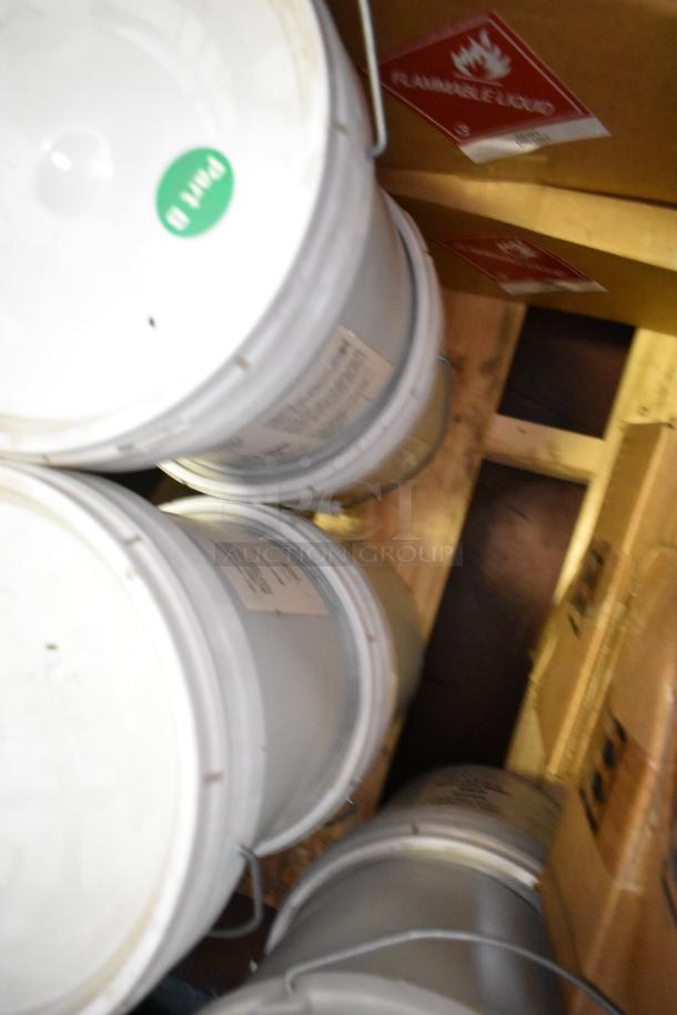 Seven buckets of Pro Guard chemicals, including EPDM Super Pipe Seal Part B, labeled "Part B" and "Flammable Liquid."