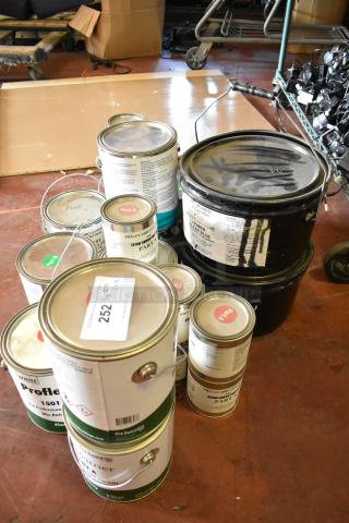 18 cans of Pro Guard chemicals including epoxy and liquid rubber. Labels show Part A/B, clear blue, moisture cure. Auction lot 252.