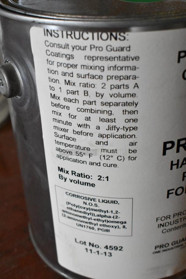 Metal can with Pro Guard Coatings instructions, emphasizing a 2:1 mix ratio, Lot No. 4592, and handling precautions.