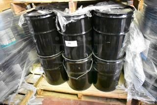 Alt text: "24 black drums of Pro Guard chemicals on pallets, including 5-gallon Moisture Cure Liquid Rubber."