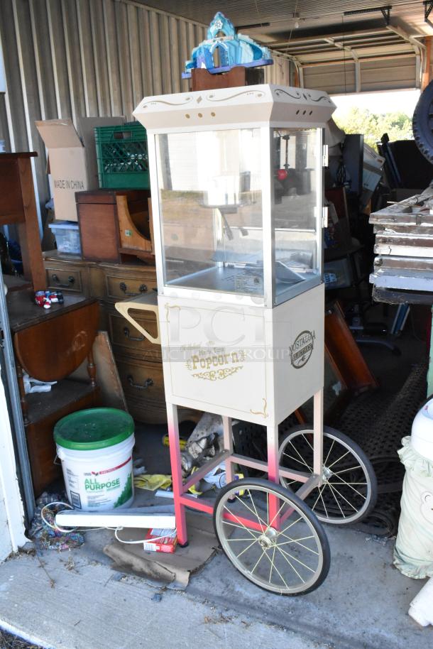 Lot of storage unit contents including vintage-style popcorn cart, children's furniture, toys, Everlast punching bag, rocking chair.
