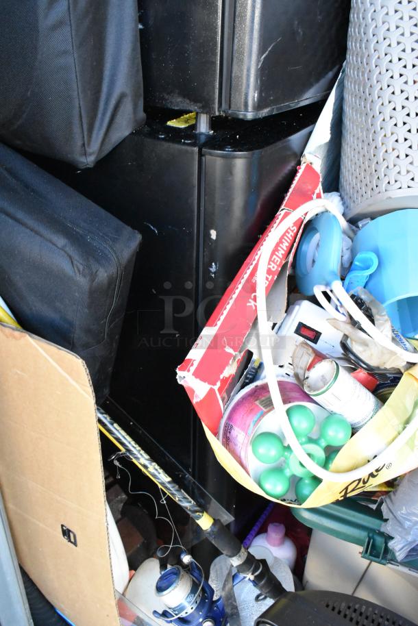 Contents of storage unit with mini cooler, Sony television, children's toys, baskets, fishing rod, and household items.