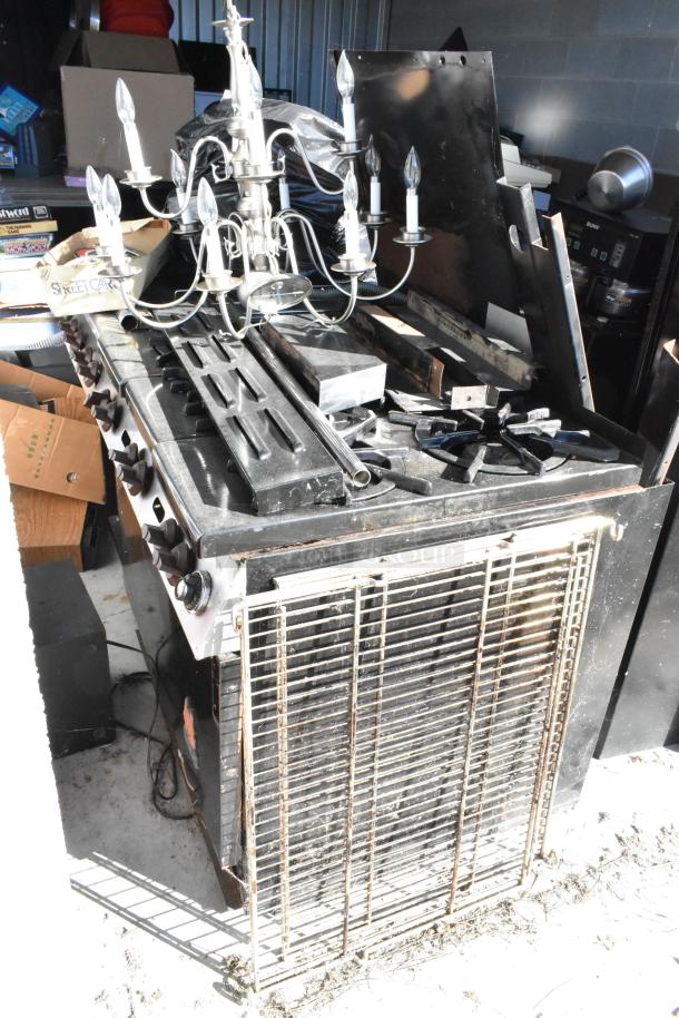 Storage Unit #60 contents: portable grill, chandelier, Bunn coffee machine. Includes boxes, weight plates. Buyer must clear unit.