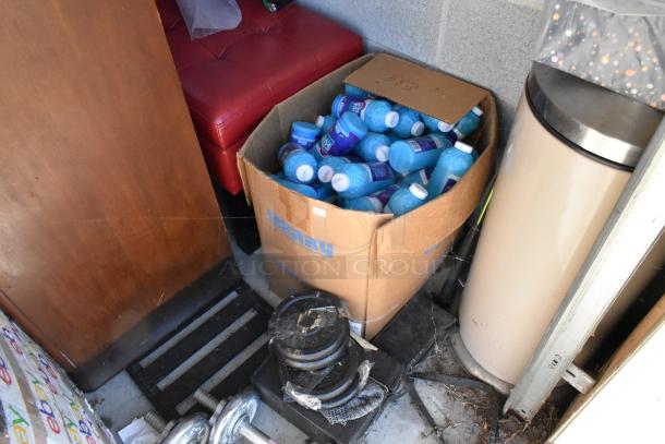 Storage unit contents include a box of blue bottles, weight plates, a red chair, and a trash can. Items sold as-is.