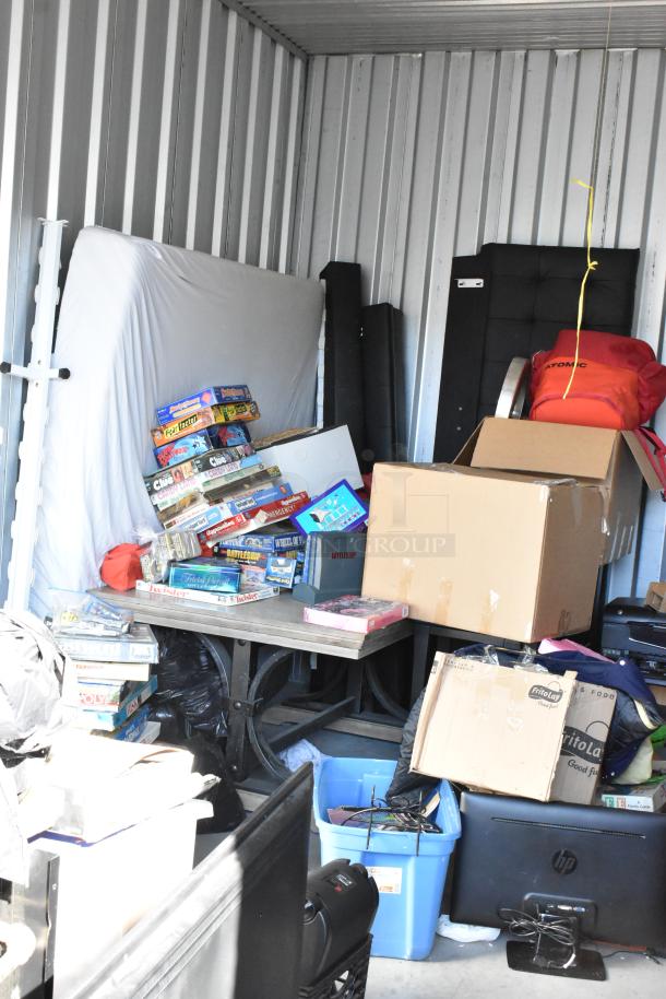 Storage unit with portable grill, board games, Bunn coffee machines, boxes, and miscellaneous items. Removal required.