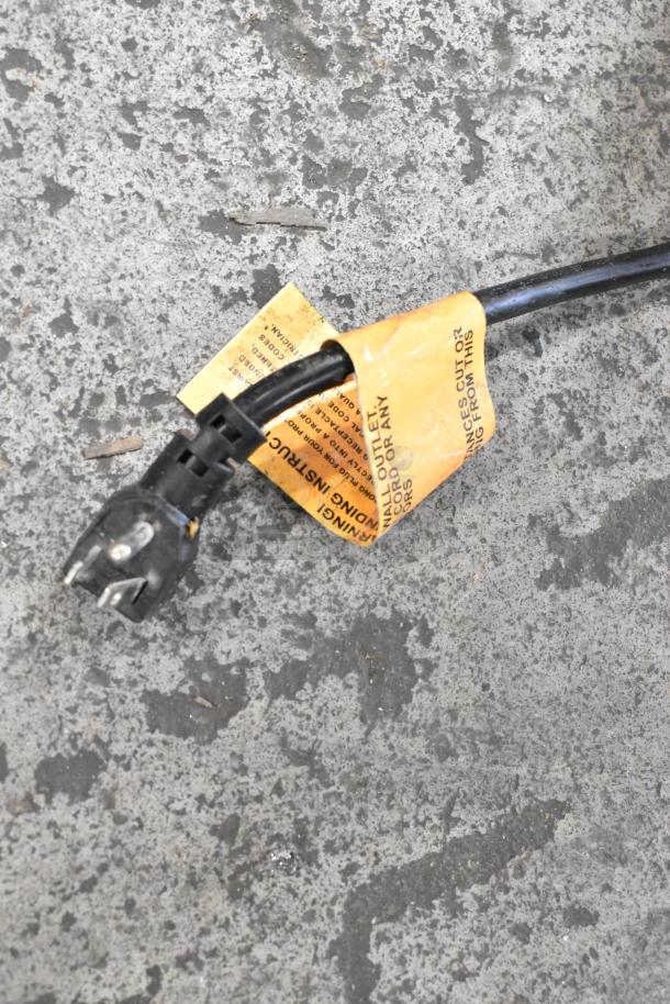Power cable with orange warning tag for 2019 Hoshizaki HR15A Ice Machine, 115V, 1 Phase. Tag indicates safety instructions.