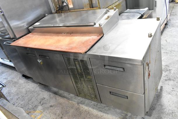 Delfield MKV9885751 stainless steel commercial pizza prep table with oversized cutting board, 2 doors, and 2 drawers.