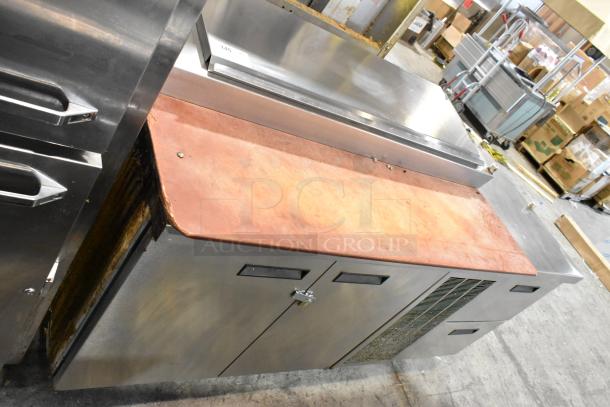 Delfield MKV9885751 stainless steel pizza prep table with oversized cutting board, two doors, two drawers, countertop space.