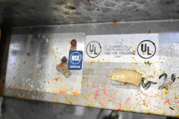 Delfield MKV9885751 stainless steel pizza prep table label, showing NSF and UL certification stamps.