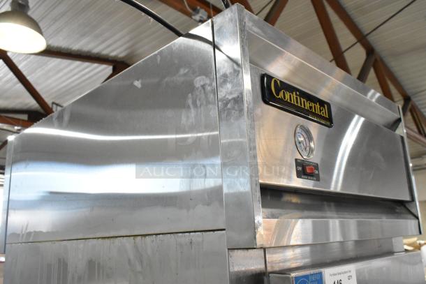 Continental 1R-SS-PT-HD stainless steel commercial cooler with two half-size doors, racks, and casters. Thermometer visible.