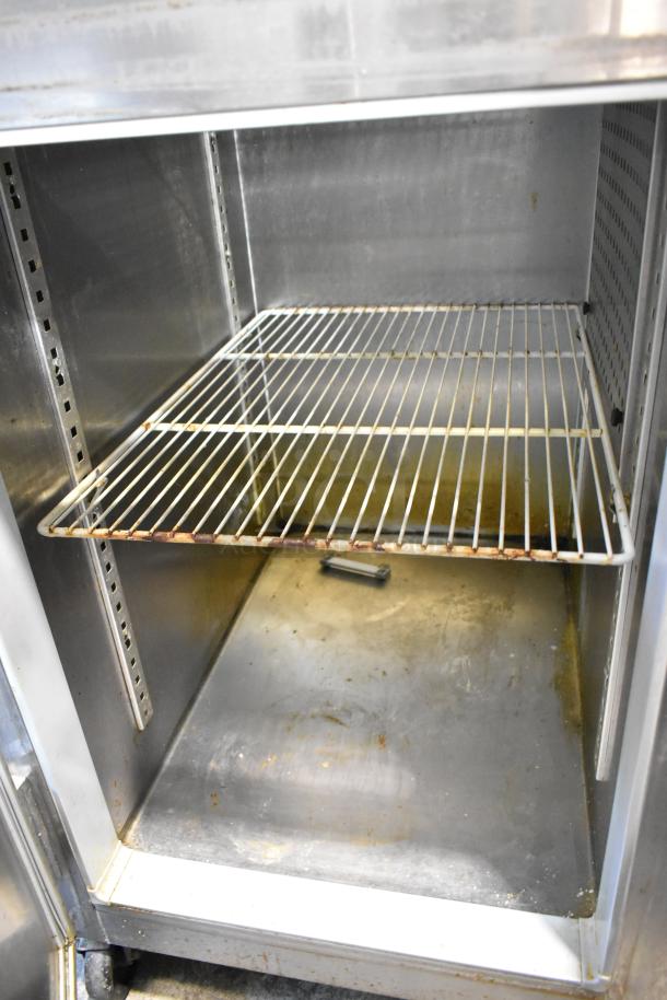 Continental 1R-SS-PT-HD stainless steel commercial cooler with racks, on commercial casters, showing interior condition.