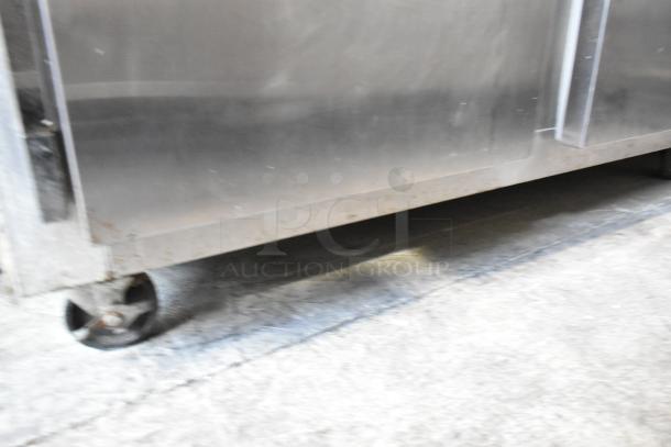 Continental 2R stainless steel 2-door reach-in cooler on commercial casters. 115V, single phase. Visible wear on casters.