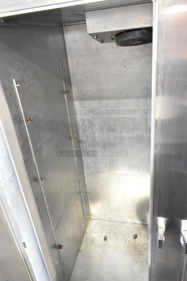 Continental 2R stainless steel commercial 2-door reach-in cooler interior, showing wear. On casters, 115 volts, 1 phase.