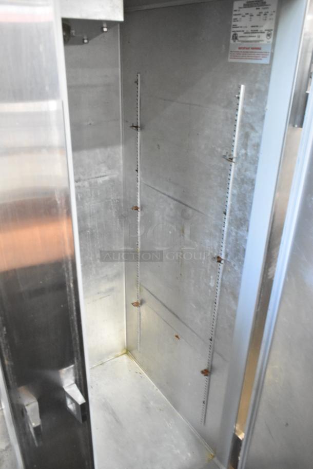 Continental 2R commercial cooler interior, stainless steel, 2 doors, commercial casters, visible model label.