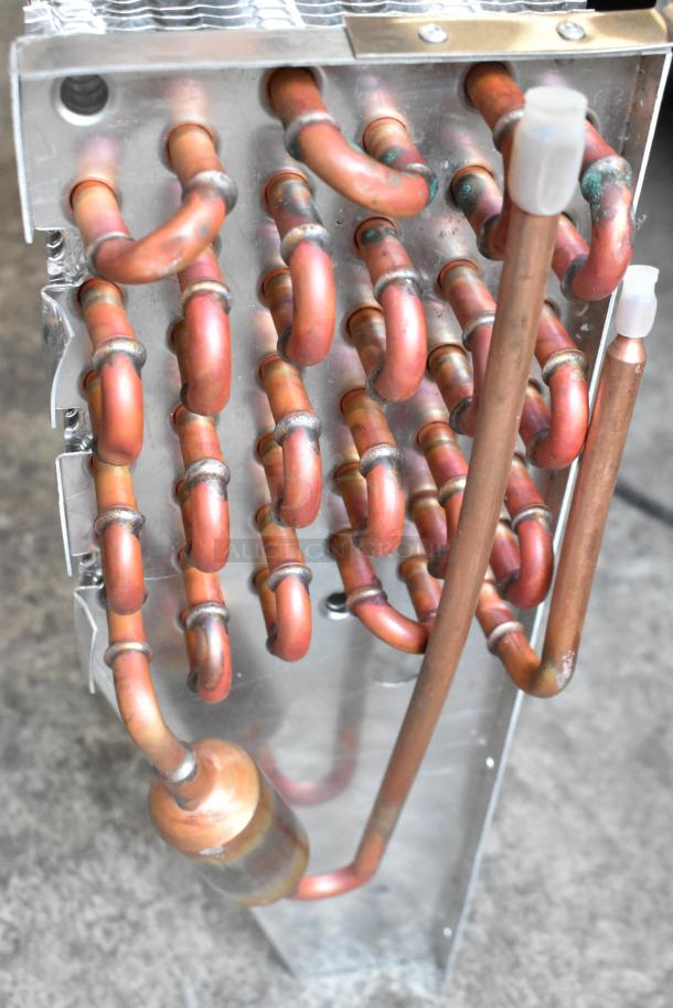 XCCC 6R7K844L evaporator coil with copper tubing, metal fins, and visible soldering joints, in good condition.