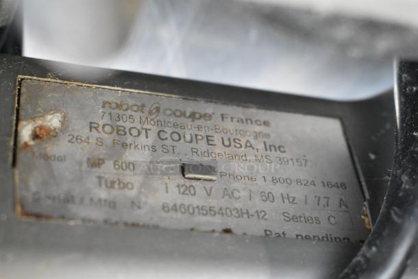 Label on Robot Coupe MP 600 Turbo Immersion Blender, showing model, serial number, and voltage details. Slight wear visible.