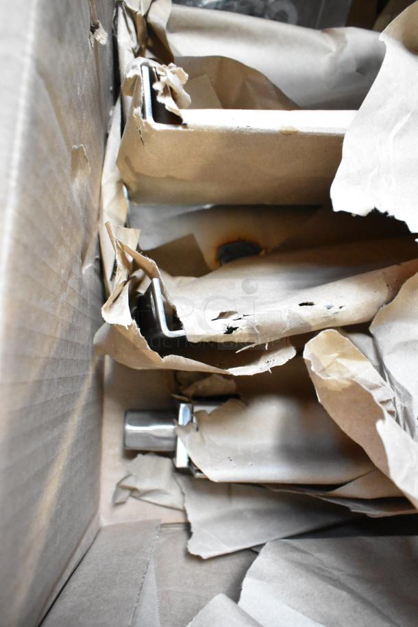 Box of 4 brand new 1951204-0003 metal legs for convection oven, wrapped in brown paper for protection.