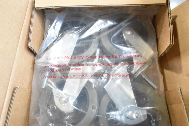 Box of 4 Steelton 465CASTER4 commercial casters, brand new with minor scratches, in plastic packaging with caution label.