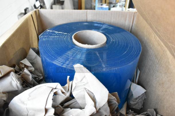 Brand new scratch and dent plastic cooler strips in a roll, shown in an open cardboard box with packing material.