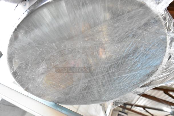 24 new metal baking pans wrapped in plastic, labeled with scratch and dent details, auction lot includes 24 items.