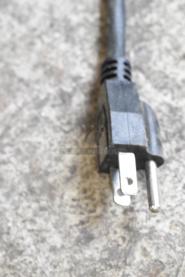 Close-up of a black electrical plug for a Winco ESH-60 heat strip warmer, 120 volts, 1 phase.