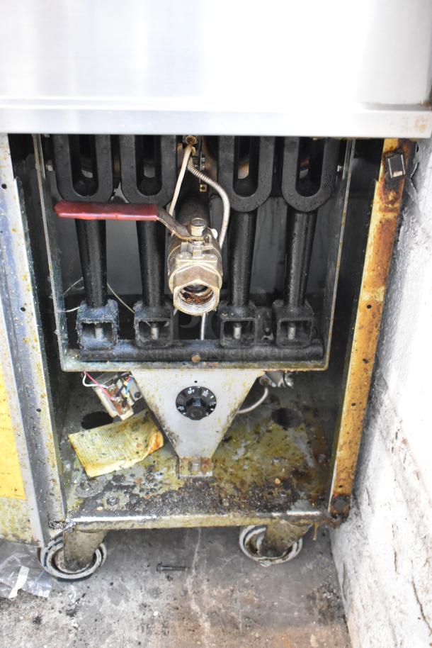 Vulcan 1GR45M stainless steel commercial gas fryer, featuring side splash guard, on casters. Visible wear with rusty edges.