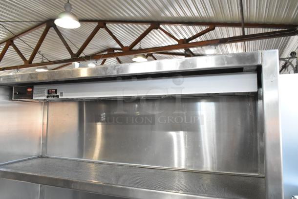 Stainless steel work station with Delfield 8146N cooler, two warming drawers, shelf, and Hatco food strip warmer. Clean condition.