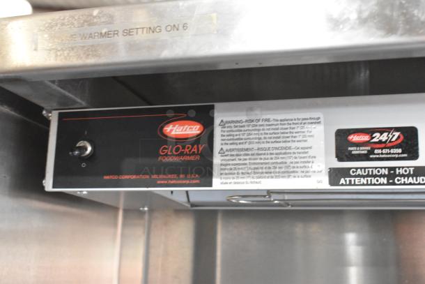 Stainless steel work station with Delfield 8146N cooler, two warming drawers, overshelf, and Hatco food strip warmer.