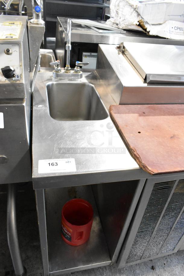 Delfield stainless steel commercial pizza prep table with sink bay, 115 volts, 1 phase, model features durable construction.