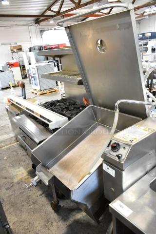 Cleveland stainless steel commercial tilting braising pan on casters, featuring control dials and visible labels, in used condition.