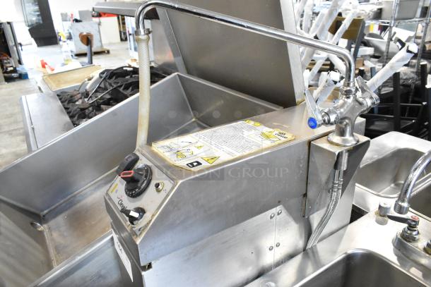 Cleveland stainless steel tilting braising pan with controls and labels, mounted on commercial casters.