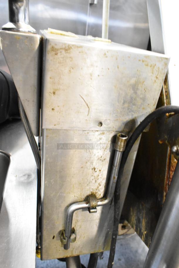 Cleveland stainless steel commercial tilting braising pan on casters, showing moderate wear and tarnish, essential for large-scale cooking.