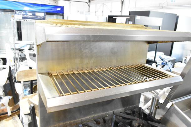 Vulcan stainless steel gas range with 6 burners, convection oven, 2-tier over shelf, backsplash, on commercial casters.