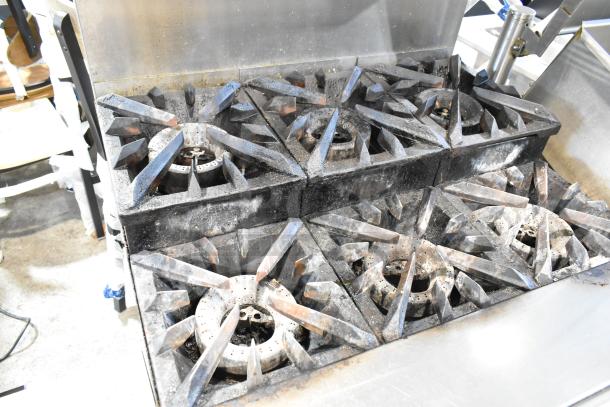 Vulcan stainless steel 6-burner commercial range with convection oven, over shelf, backsplash, and casters. Used condition.