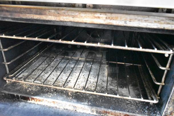 Vulcan Stainless Steel 6 Burner Gas Range with Convection Oven, 2-tier shelf, backsplash, on casters. Interior view shown.
