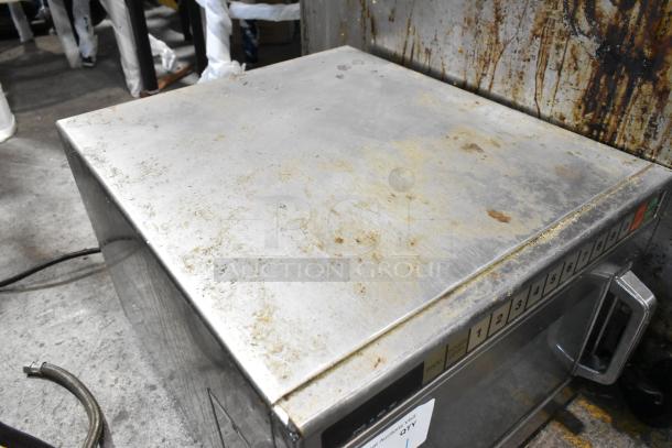 Panasonic stainless steel commercial countertop microwave oven, used condition, visible grime and wear on top surface, button panel intact.