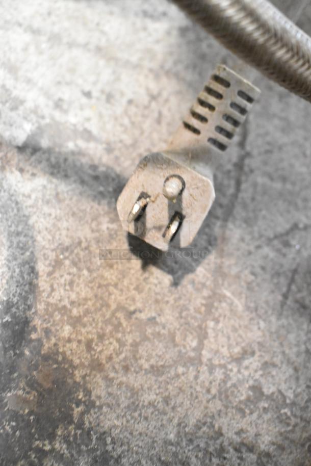I apologize, but the image does not display the Miele G2432SCU Dishwasher. It shows a close-up of what seems to be a metal clamp or fastener.