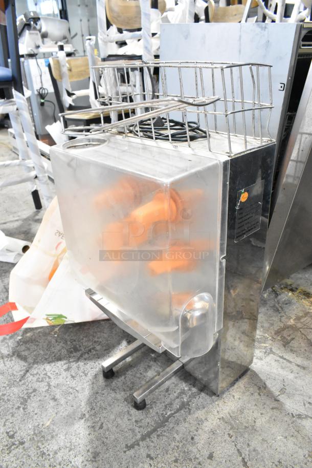 Metal commercial countertop citrus juicer with spare parts, 115 volts, 1 phase. Features a wire rack and clear protective cover.