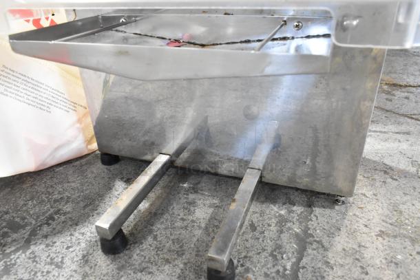 Commercial countertop citrus juicer, metal, includes spare parts, 115 volts, 1 phase, slightly worn condition.