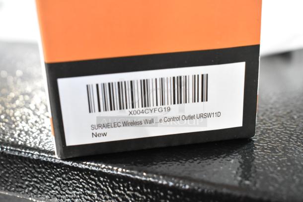 Brand new Suraielec Wireless Wall Switch Outlet in box, model URSW11D, with barcode and label showing product details.