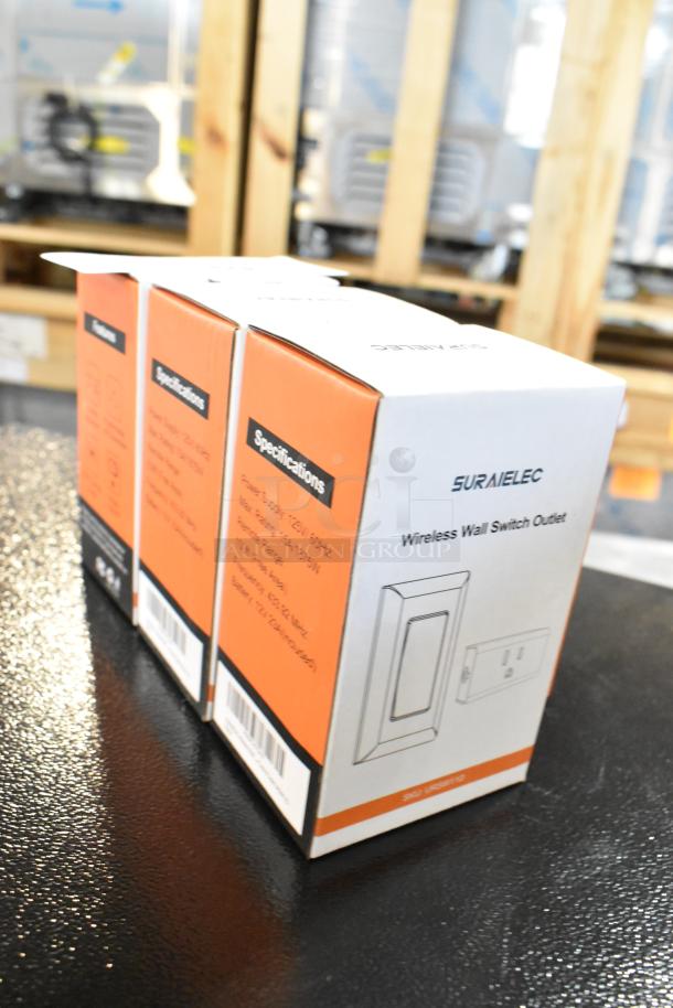 Three brand new Suraielec Wireless Wall Switch Outlets in original packaging, specifications visible.
