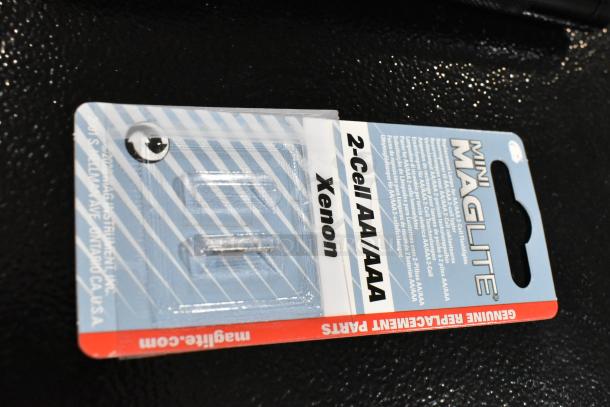 Maglite flashlight package, 2-Cell AA/AAA model, genuine replacement parts label, xenon bulb, new condition.