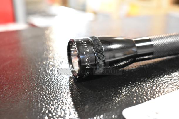 Maglite flashlight, black, 2 cell AA/AAA, accurate focus, durable build, near mint condition, textured grip.