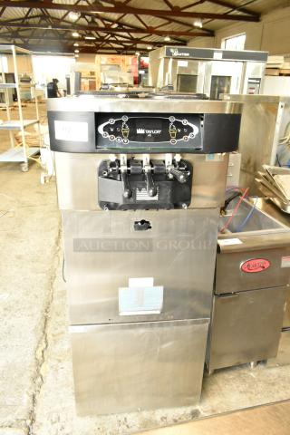 Taylor stainless steel 2-flavor soft serve ice cream machine on casters, commercial model, 208-230V, 1 phase.