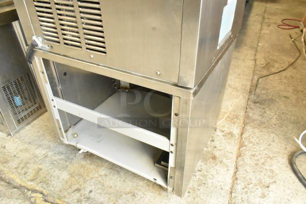 Taylor stainless steel 2-flavor soft serve ice cream machine, commercial floor model, with twist feature, on casters.