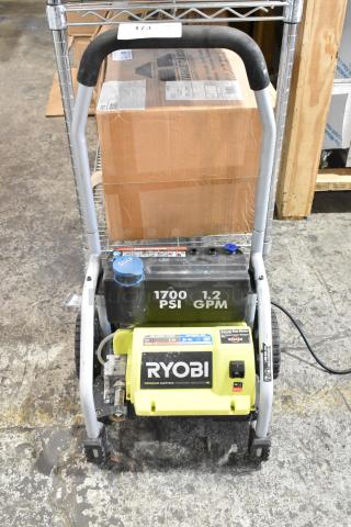 Ryobi 1700 PSI 1.2 GPM electric pressure washer in used condition. Features sturdy frame and visible soap tank. ع