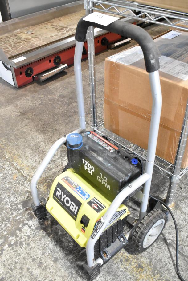 Ryobi 1700 PSI 1.2 GPM electric pressure washer with visible soap nozzle and handle. Appears in used condition.