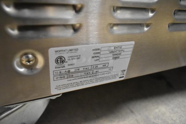 Moffat Turbofan EHT10 heated cabinet label showing model, voltage 208V, 1 phase, and serial number. Stainless steel finish.
