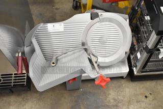 Berkel X13-PLUS metal automatic meat slicer, new scratch and dent, with blade sharpener, 120V, 1-phase, on countertop.